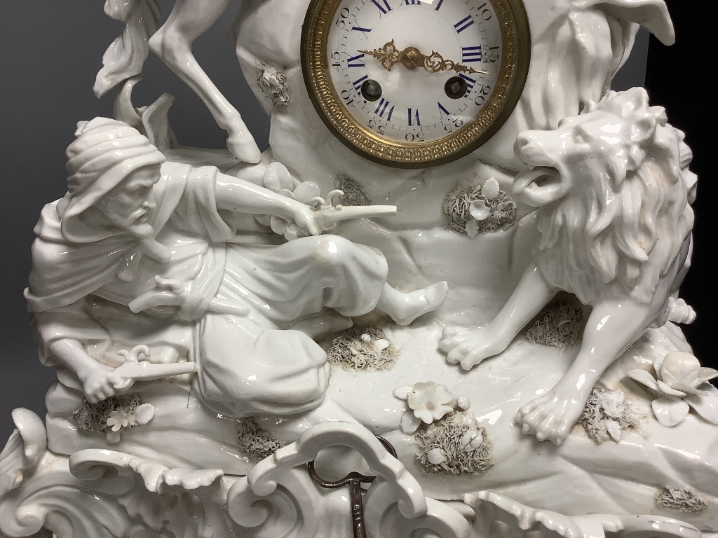 A 19th century German porcelain mantel clock modelled as a lion hunt, height 63cm